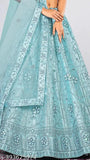 Elegant sky blue net semi-stitched Lehenga Choli & Dupatta with matching embellishments, perfect for special occasions like weddings