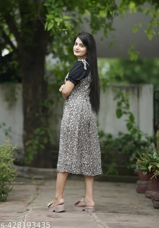 FloraPuff Elegance Viscose Rayon Dress - Floral printed knee-length two piece with puffed black sleeves and lace detailing, perfect for casual outings or daytime events