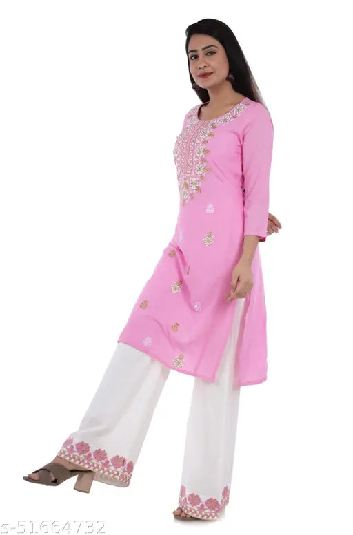Embroidered rayon kurta set with palazzo, featuring three-quarter sleeves and print all over. Stylish women's attire from Elvish Jaipur, India