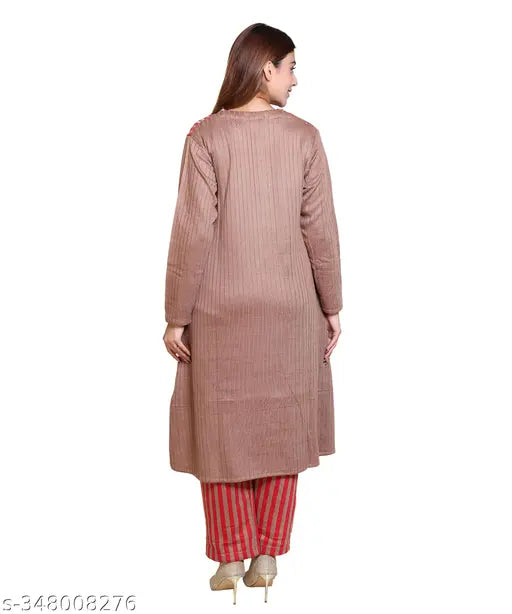 The image displays a woman in a long kameez, standing against a light background. Her kameez is of a mustard color, and she has red trousers on. The top appears to be cropped at the waist. The style suggests an ethnic outfit typically worn in South Asian cultures. There are no visible texts or additional objects that provide more context about the product or setting