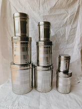 Silver stainless steel vertical canister set of 8, featuring varying sizes: 350ML, 500ML, 700ML, 900ML, 1.25Ltr, 1.6Ltr, 2.2Ltr, 2.9Ltr