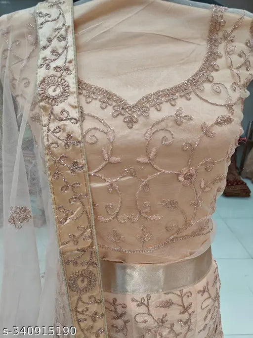 Peach satin-net lehenga, embellished with zari work, semi-stitched Indian party wear