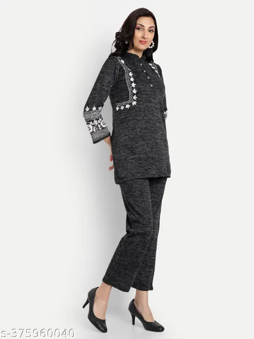 Black velvet embroidery night suit/co-ord set by Elendra, featuring high-low V neck tunic and pants for women's winter wear. Comfortable and versatile, perfect for casual outings. Made in India