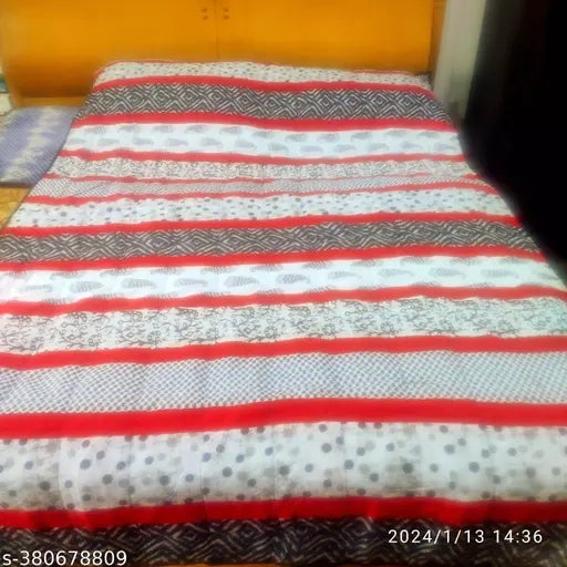 Black and white hand-quilted cotton quilt, geometric pattern on display in AC room