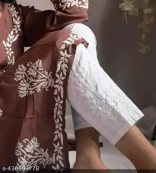 White cotton pant with chikankari embroidery, perfect for pairing with kurtas and dresses. Made of 100% cotton. Hand wash separately in cold water. Indian-made