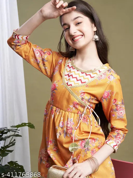 Floral printed polycotton kurta with sharara set in mustard color, anarkali style with 3/4 sleeves and lace border. Traditional yet contemporary ethnic wear for girls aged 8-15 years