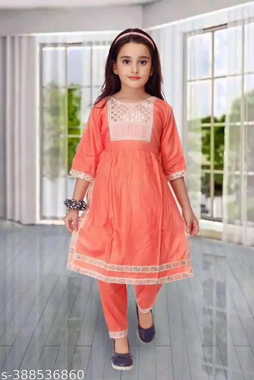 Orange cotton blend pyjama set with A-line silhouette, embellished sleeves, and ethnic design. Indian girls ethnic wear for parties and casual occasions
