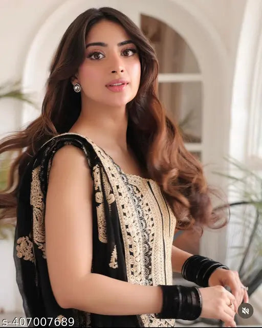 Sleeveless embroidered Georgette kurta set with dupatta and silk bottomwear. Indian hand-stitched fashion on mannequin