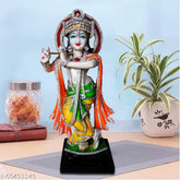 Resin Krishna Idol, 11cm tall, handcrafted with white marble finish, vibrant clothing and decorative stones. Bright and contrasting colors
