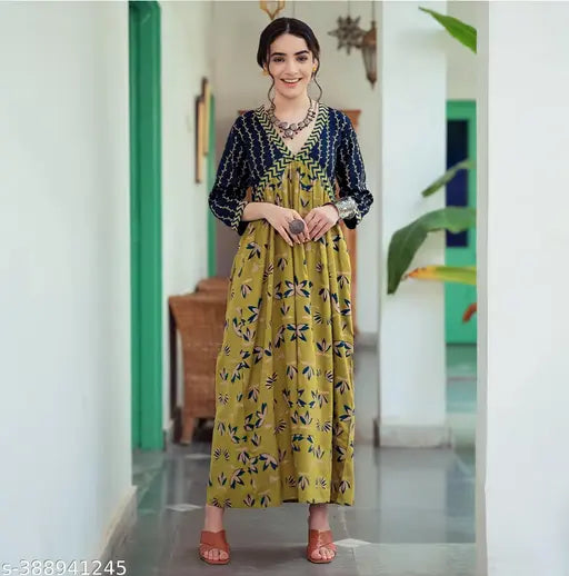 Yellow rayon kurti gown with vibrant botanical print, three-quarter sleeves, V-neck. Indian handcrafted party wear for women