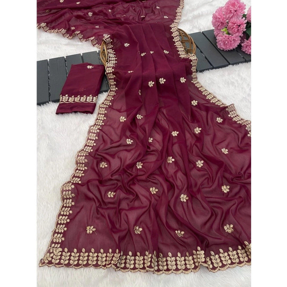 Red georgette embroidered saree with unstitched blouse, intricate floral design on display rack