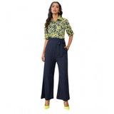 Navy-Yellow polyester floral half sleeves jumpsuit with shirt collar neck and ankle length bottom, on model