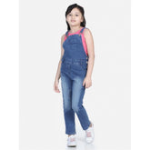 Blue denim washed dungaree for girls, buttoned waist with round neck, casual playwear on grassy field