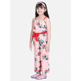 Peach-red floral polyester crepe girl's jumpsuit with shoulder straps, square neckline on model