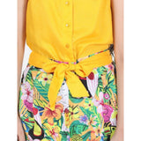 Yellow-multicolor rayon flamingo print sleeveless jumpsuit for girls, vibrant summer attire on model