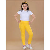 Yellow cotton lycra elasticated leggings for girls, solid design with comfort fit