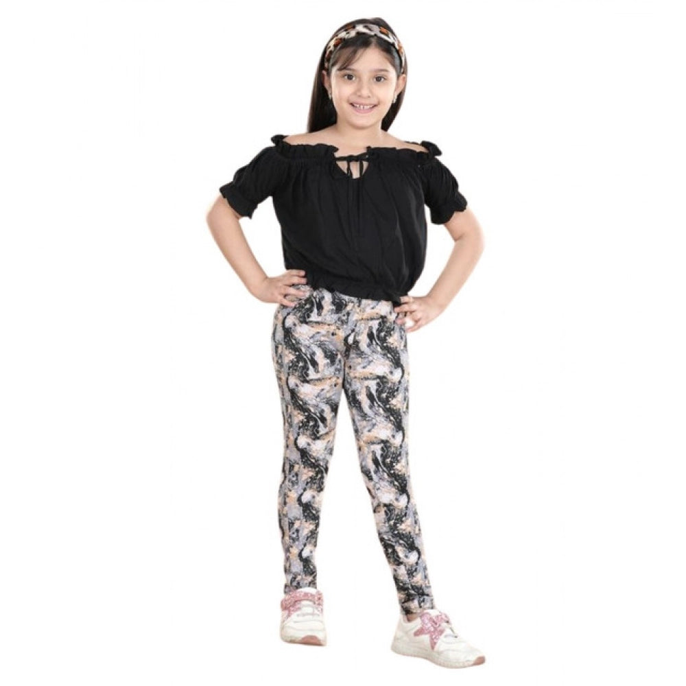 Black cotton floral elasticated jegging and top set for girls, floral pattern with shoulder strap top and elastic waist bottoms on display