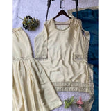Cream & Teal silk embroidered V-neck kurti with sharara pant and dupatta set, intricate patterns on traditional Indian wear