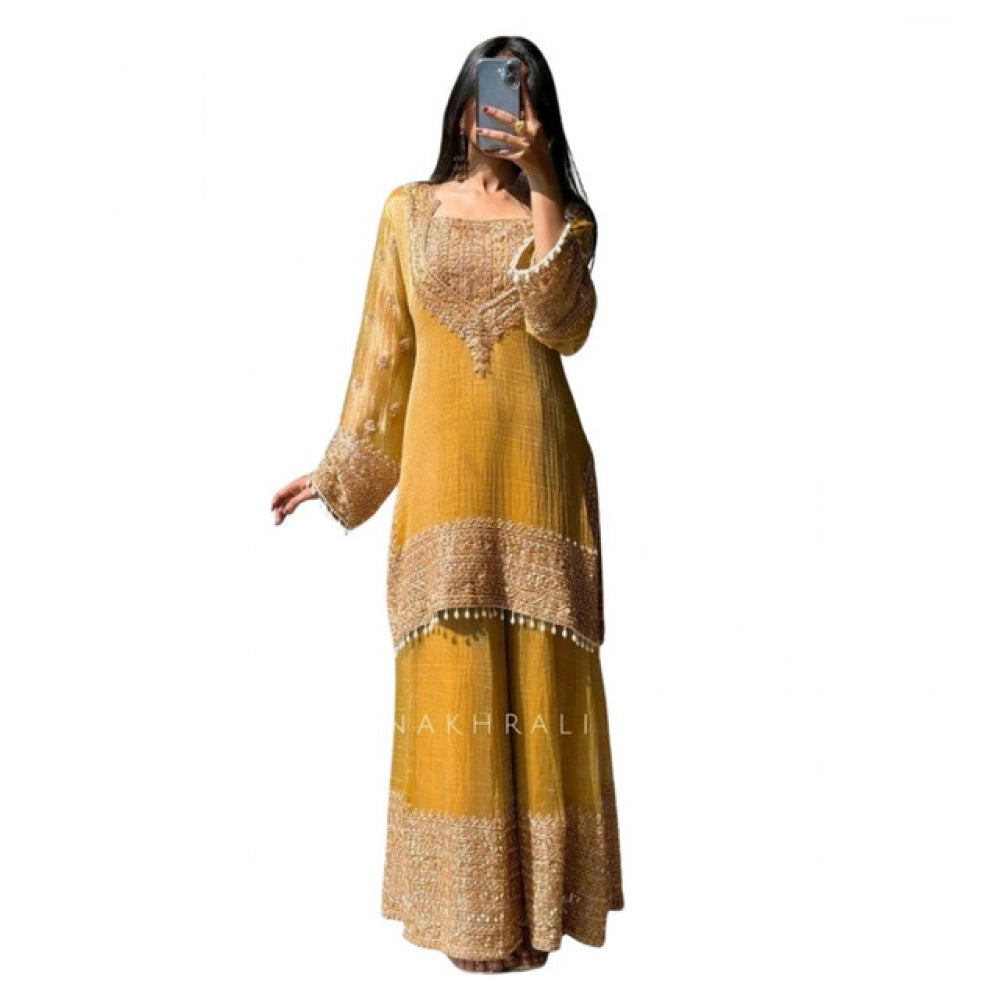 Yellow silk embroidered 3/4th sleeve round kurti set with sharara pant and dupatta, traditional Indian attire on display