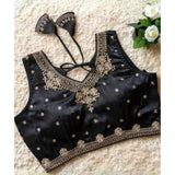 Black silk embroidered V-neck sleeveless blouse with padded detail on a size 38 mannequin