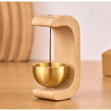 { "alt_text": "Gold magnetic doorbell with natural wooden base, adhesive door chime for home entrance or garden gate" }