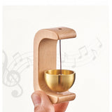 { "alt_text": "Gold magnetic doorbell with natural wooden base, adhesive door chime for home entrance or garden gate" }