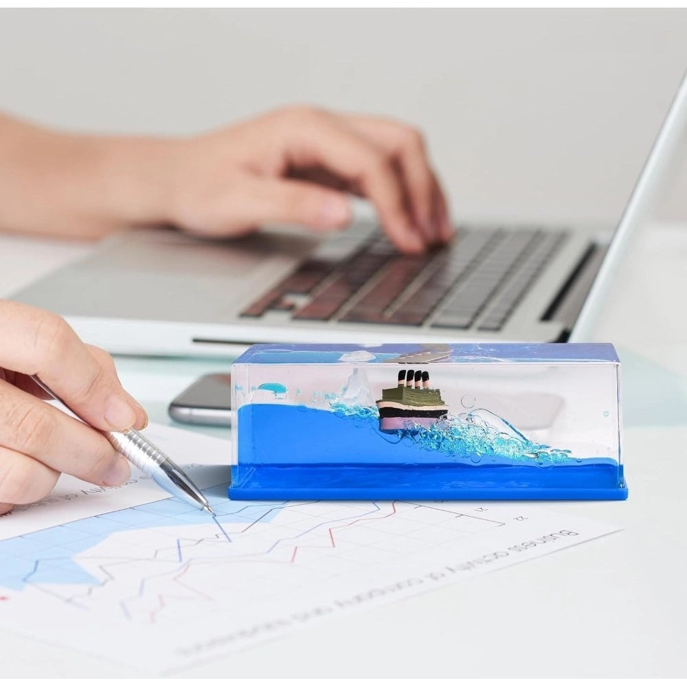 { "alt_text": "Blue PVC decorative liquid wave cruise ship ornament, perfect desk paperweight for home office decor" }