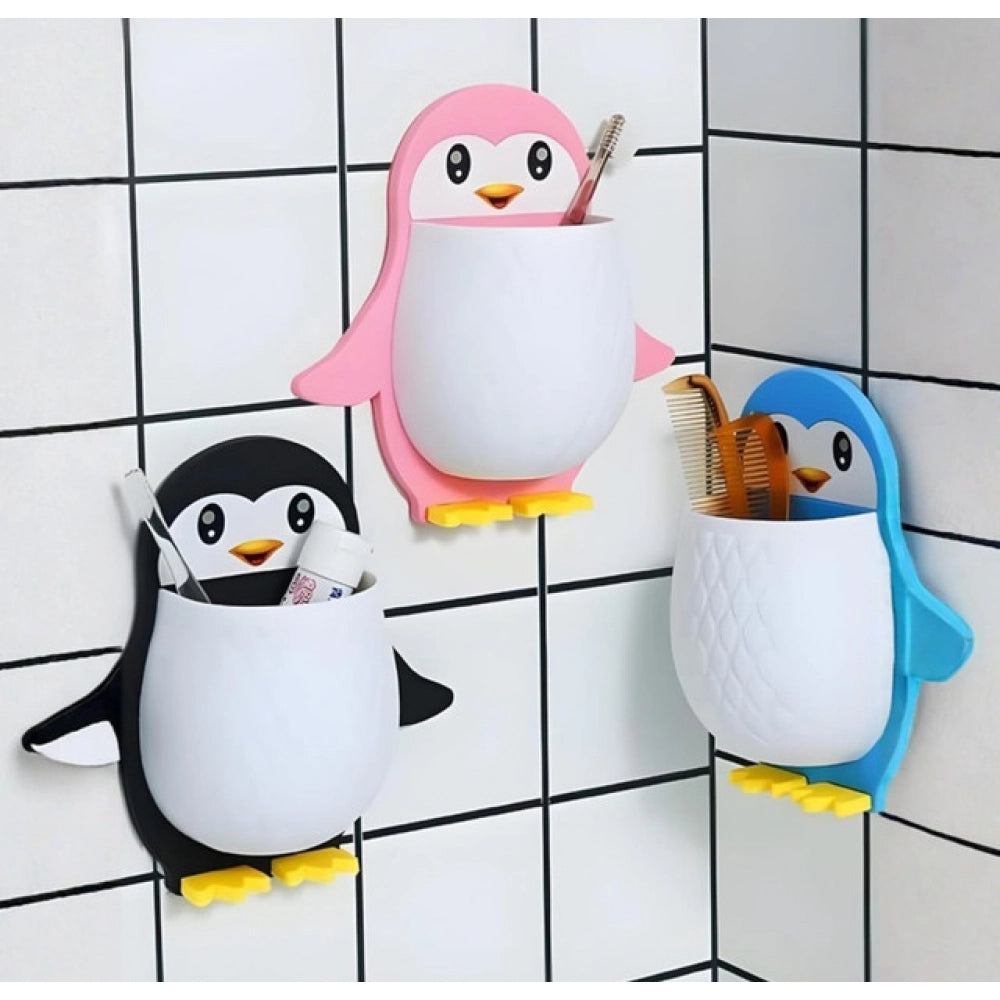 { "alt_text": "Multicolor plastic toothbrush holder set of 3, penguin design bathroom organizer for countertop storage" }