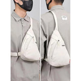 { "alt_text": "Off-white nylon chest bag unisex crossbody bags for women, stylish travel accessory for daily wear" }