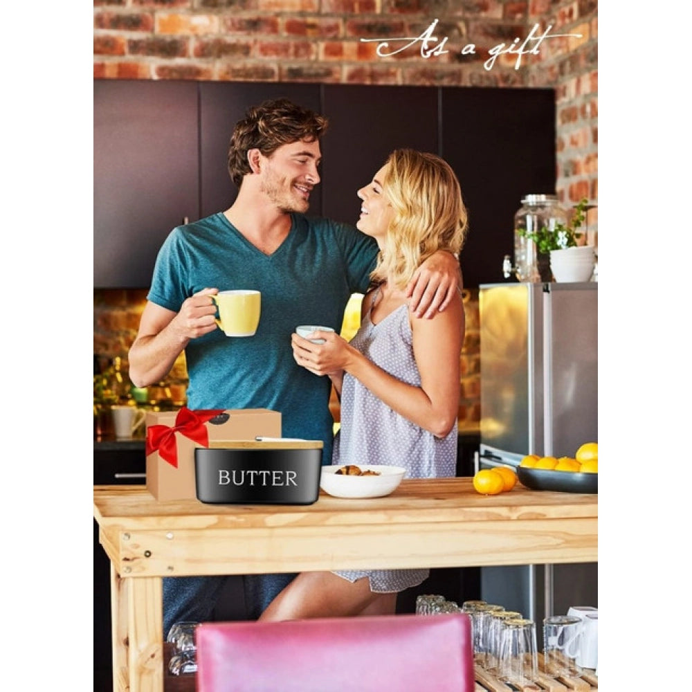 { "alt_text": "Black ceramic butter box with bamboo lid, airtight storage container for fresh butter, kitchen countertop accessory" }