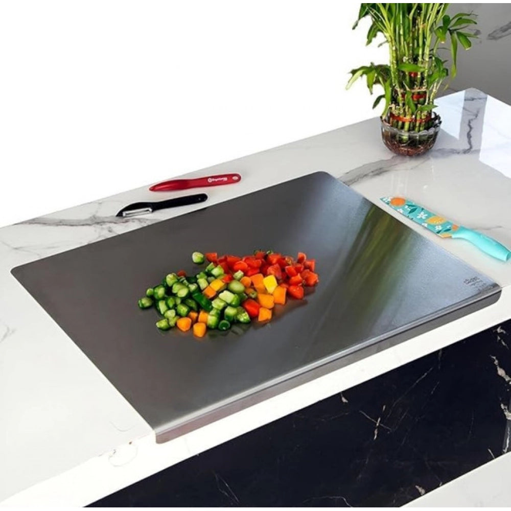 { "alt_text": "Silver stainless steel chopping board for kitchen prep, durable food preparation tool with built-in lip" }