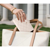 { "alt_text": "Beige PU leather jewelry organizer book with velvet interior, expandable jewelry storage box for travel" }