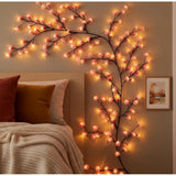 { "alt_text": "Multicolor LED vine light, bendable floral wall decor, warm yellow pink glow for bedroom mood lighting" }