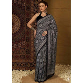 { "alt_text": "Black crepe printed saree with unstitched blouse, 5.5m, ethnic wear, Indian fashion, traditional attire" }