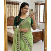 { "alt_text": "Green georgette embroidered saree with unstitched blouse, star print ethnic wear, 5.5 meter Indian clothing" }