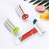 { "alt_text": "Multicolor plastic toothpaste squeezer pack of 2, easy-to-use bathroom hygiene tool" }