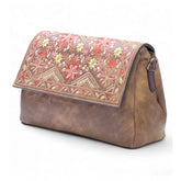 { "alt_text": "Brown polyurethane crossbody sling bag with floral embroidery, adjustable strap, women's fashion accessory" }