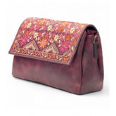 { "alt_text": "Red polyurethane crossbody sling bag with floral embroidery, adjustable strap, women's fashion accessory" }