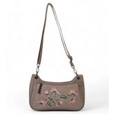 { "alt_text": "Beige polyurethane crossbody sling bag with floral embroidery, adjustable strap, women's fashion accessory" }