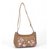 { "alt_text": "Tan polyurethane crossbody sling bag with floral embroidery, adjustable strap, women's fashion accessory" }