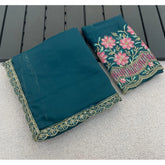 { "alt_text": "Teal georgette saree with embellishment, unstitched blouse, 5.5 meter ethnic wear for women" }