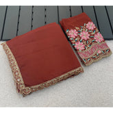 { "alt_text": "Brown georgette saree with embellishment, unstitched blouse, 5.5 meter ethnic wear for women" }