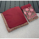 { "alt_text": "Maroon georgette saree with embellishment, unstitched blouse, 5.5 meter ethnic wear for women" }