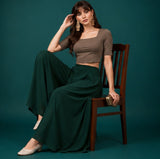 { "alt_text": "Bottle green georgette women's palazzo pants, solid wide leg flared pants, mid-rise ankle length clothing" }