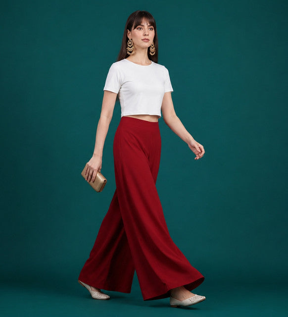 { "alt_text": "Maroon georgette women's palazzo pants, solid wide leg flared pants, mid-rise elastic waist ankle length" }