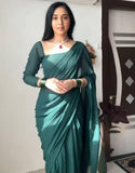 { "alt_text": "Dark green georgette solid saree with unstitched blouse, 5.5 meter ethnic wear, Indian fashion" }
