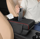 Black and red faux leather car arm rest cushion with memory foam, cup holders, and phone storage compartment