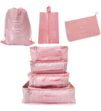 Pink nylon 7-piece travel packing cube set with various organizers for clothes, shoes, and toiletries