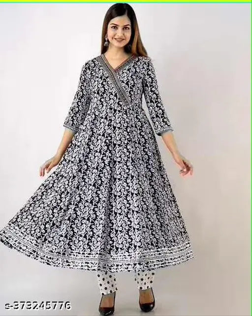 Black rayon Aliya cut gown with long sleeves, printed net pattern. Size M available