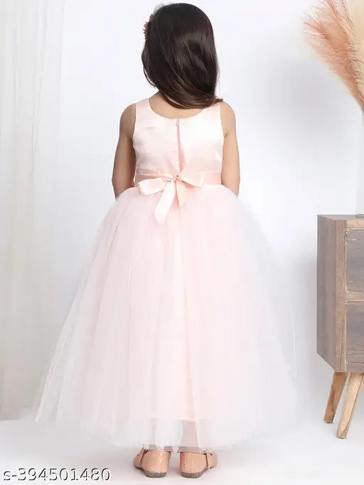 Light peach net dress, fit and flared, embellished for girls' parties. Made in India